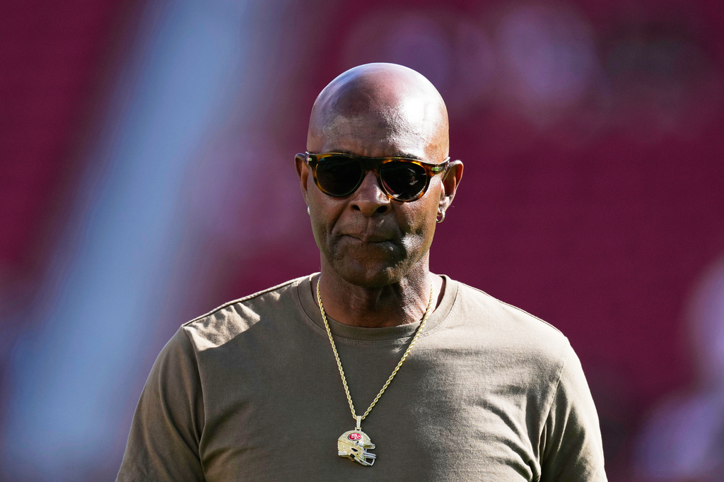FILE - Former San Francisco 49ers player Jerry Rice walks on the field before an NFL preseason football game between the 49ers and the Los Angeles Chargers, in Santa Clara, Calif., Aug. 23, 2025. (AP Photo/Godofredo A. Vásquez, File)