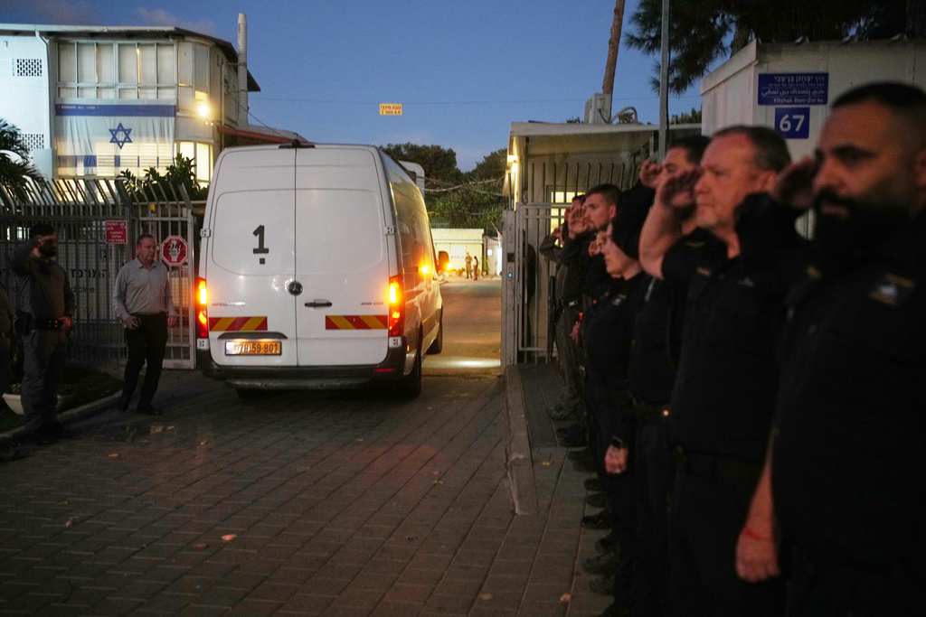 A vehicle carrying the remains of a person whom Hamas claims is a deceased hostage, transferred earlier today by Gaza militants to Israeli authorities, arrives at the Abu Kabir Forensic Institute in Tel Aviv, Israel, Tuesday, Dec. 2, 2025. (AP Photo/Ohad Zwigenberg)