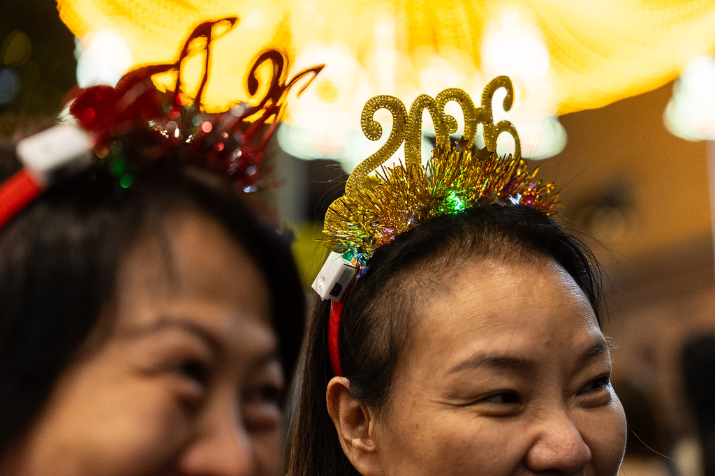 People attend the New Year countdown event to celebrate the start of 2026 in the Central district of Hong Kong, on Wednesday, Dec. 31, 2025. (AP Photo/Chan Long Hei)