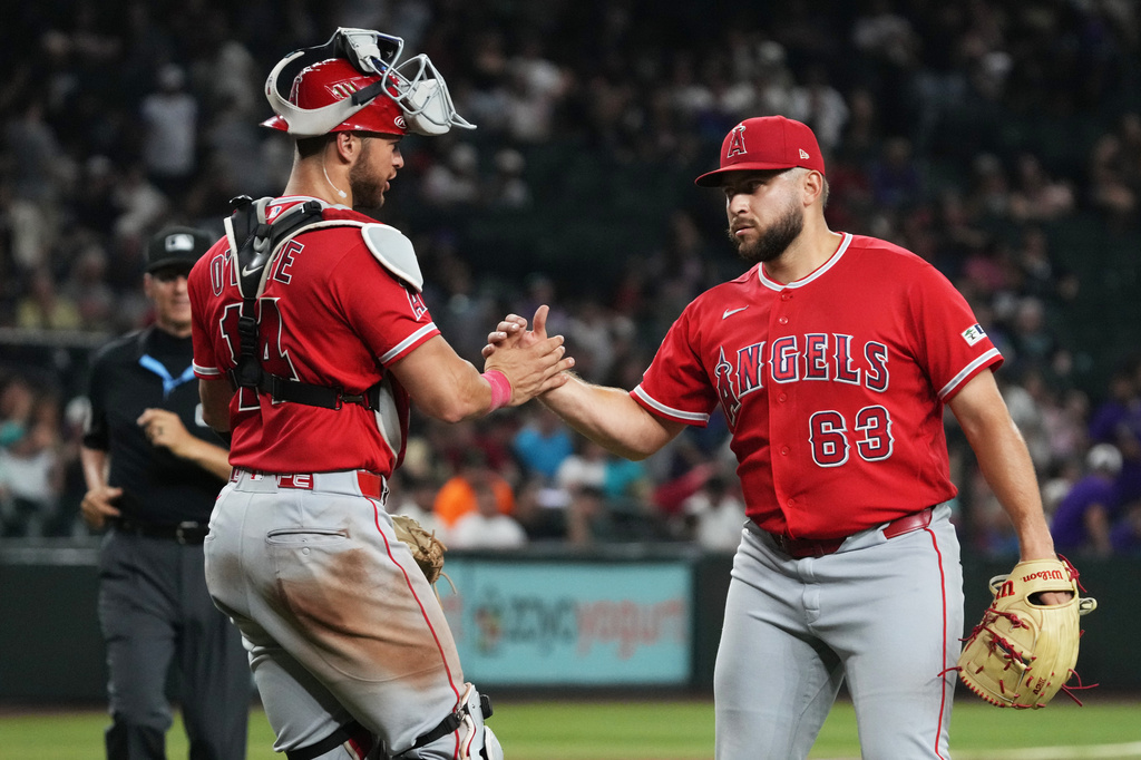 Los Angeles Angels catcher Logan O'Hoppe (14) and pitcher Chase Silseth celebrate after defeating the Arizona Diamondbacks a baseball game, Tuesday, June 16, 2026, in Phoenix. (AP Photo/Rick Scuteri)