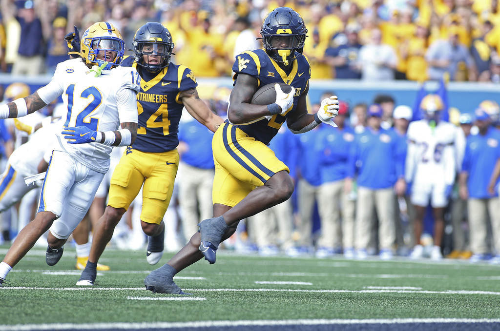 West Virginia Mountaineers running back Tye Edwards (2) runs it in for a touchdown during the first half of an NCAA college football game against Pittsburgh Saturday, Sept. 13, 2025, in Morgantown, W.Va. (AP Photo/Kathleen Batten)