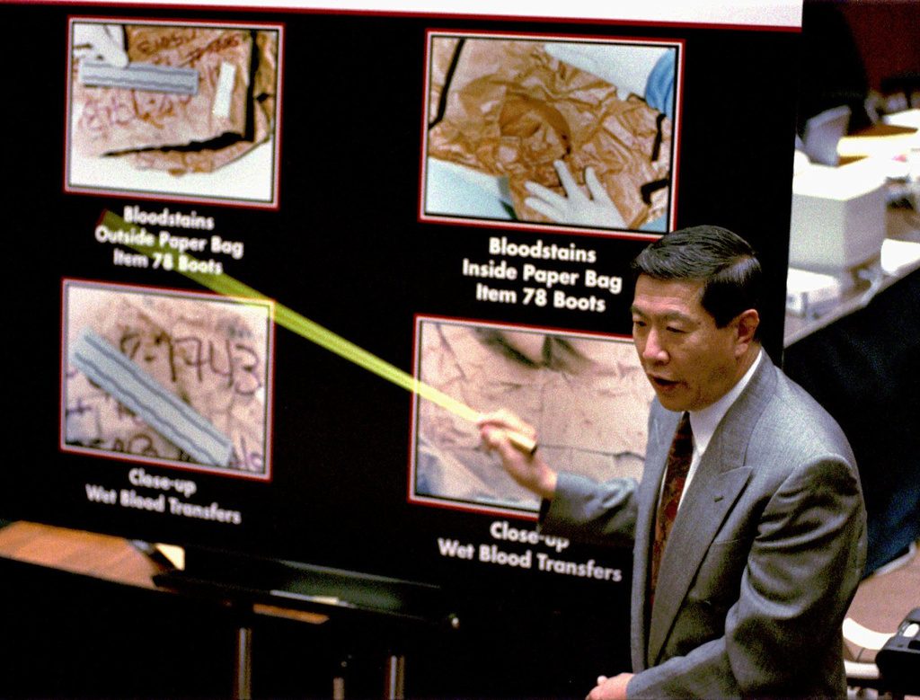 FILE - Defense witness forensic scientist Henry Lee uses a pointer as he describes how blood stains were transferred from evidence items to the paper bags they were carried in during the O.J. Simpson double-murder trial, Aug. 25, 1995, in Los Angeles. (AP Photo/Reed Saxon, File)