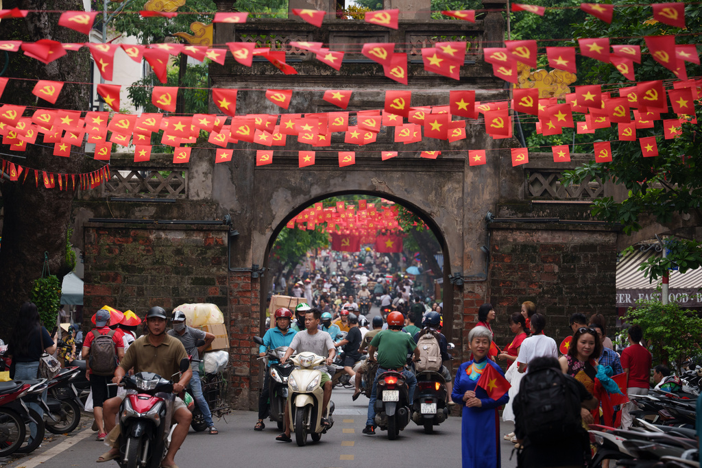 CORRECTS TO CALL THE AREA THE OLD QUARTER - Vietnamese ride two-wheelers in the Old Quarter area in Hanoi, Vietnam, on Sept. 1, 2025. (AP Photo/Vincent Thian)
