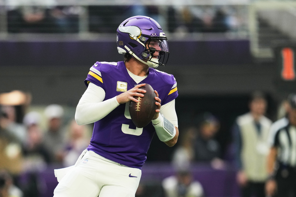 Minnesota Vikings quarterback J.J. McCarthy (9) drops back to pass against the Baltimore Ravens in the first half of an NFL football game, Sunday, Nov. 9, 2025, in Minneapolis. (AP Photo/Abbie Parr)
