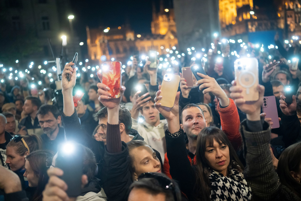 FILE -People listen to the speech of former Hungarian government insider Peter Magyar next to Kossuth Square on Tuesdy, in Budapest, Hungary, March 26, 2024. (AP Photo/Denes Erdos, File)