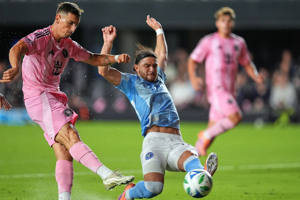 Inter Miami forward Tadeo Allende, left, scores his side's first goal past New York City FC midfielder Justin Haak during the first half of an MLS Eastern Conference final soccer match, Saturday, Nov. 29, 2025, in Fort Lauderdale, Fla. (AP Photo/Rebecca Blackwell)