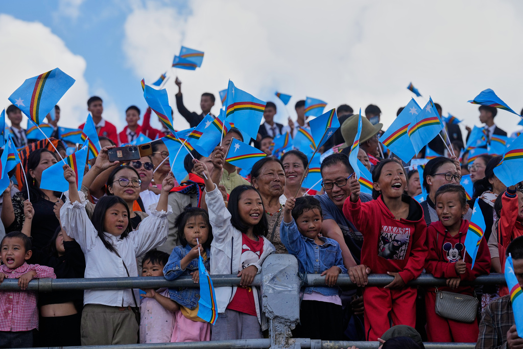 People wave the Naga flag and welcome Thuingaleng Muivah, leader of the National Socialist Council of Nagaland (Isak-Muivah), in Ukhrul, in the northeastern Indian state of Manipur, Wednesday, Oct. 22, 2025. (AP Photo/Anupam Nath)