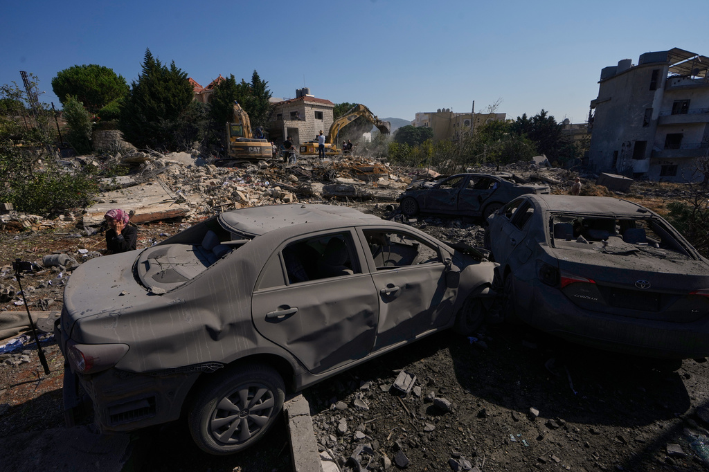 Rescue workers search for victims under the rubble of a building destroyed in an Israeli airstrike in the southern village of Kfar Rumman, Lebanon, Monday, Sept. 7, 2026. (AP Photo/Mohammed Zaatari)