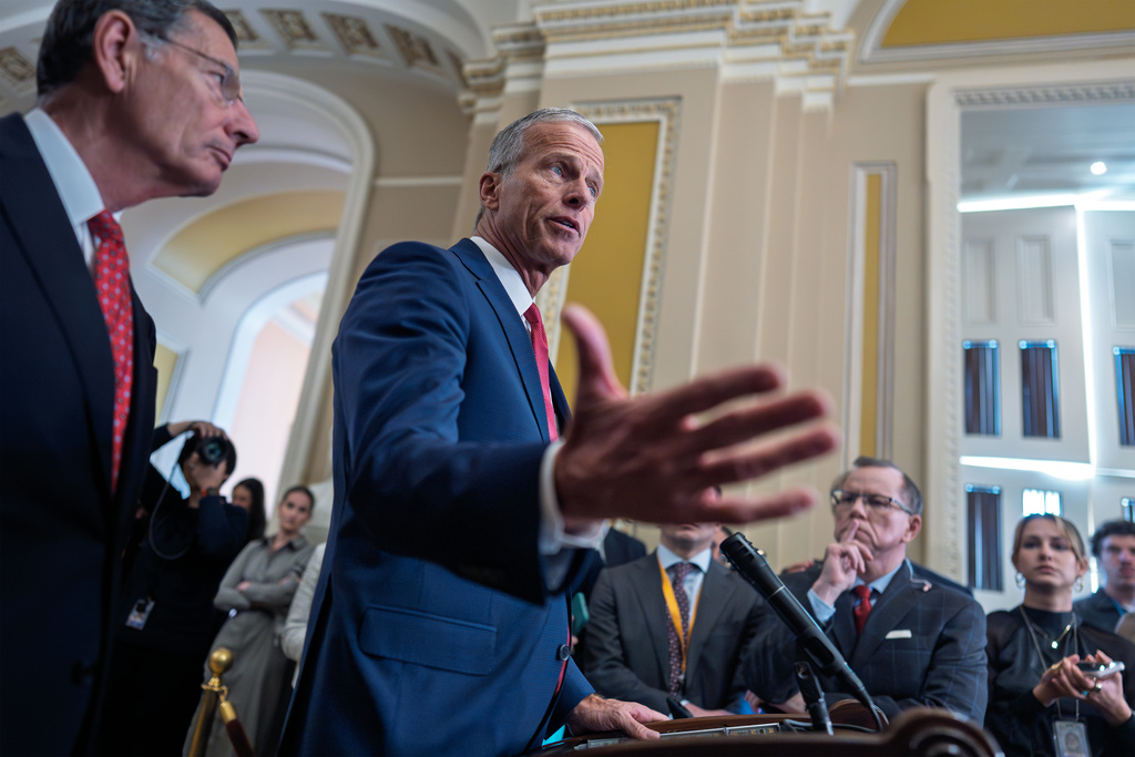 Senate Majority Leader John Thune, R-S.D., joined at left by Sen. John Barrasso, R-Wyo., the GOP whip, talks with reporters following a closed-door strategy session, on day 35 of the government shutdown, at the Capitol in Washington, Tuesday, Nov. 4, 2025. (AP Photo/J. Scott Applewhite)