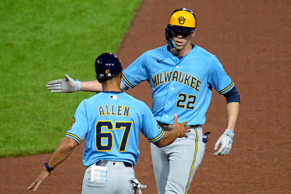 Milwaukee Brewers' Christian Yelich (22) celebrates with first base coach Spencer Allen after driving in two runs with a single off Pittsburgh Pirates pitcher Carmen Mlodzinski during the seventh inning of a baseball game in Pittsburgh, Wednesday, Sept. 16, 2026. (AP Photo/Gene J. Puskar)