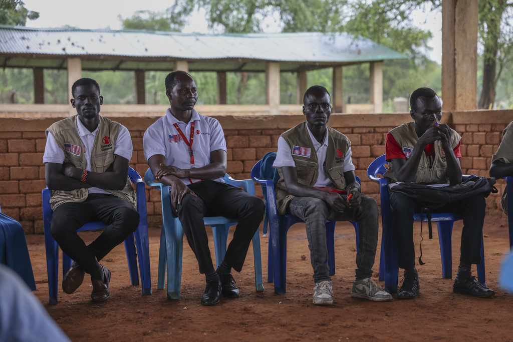 Aid workers with an international aid group in the Maban Office sit in Doro Refugee Camp Community Centre, Maban, South Sudan, Aug 19, 2025. (AP Photo/Caitlin Kelly)