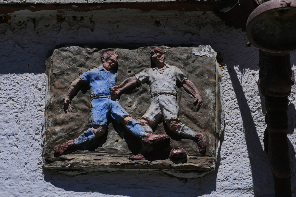 Art dedicated to soccer hangs on the wall of a home in Real del Monte, Hidalgo state, Mexico, Thursday, May 14, 2026. (AP Photo/Marco Ugarte)