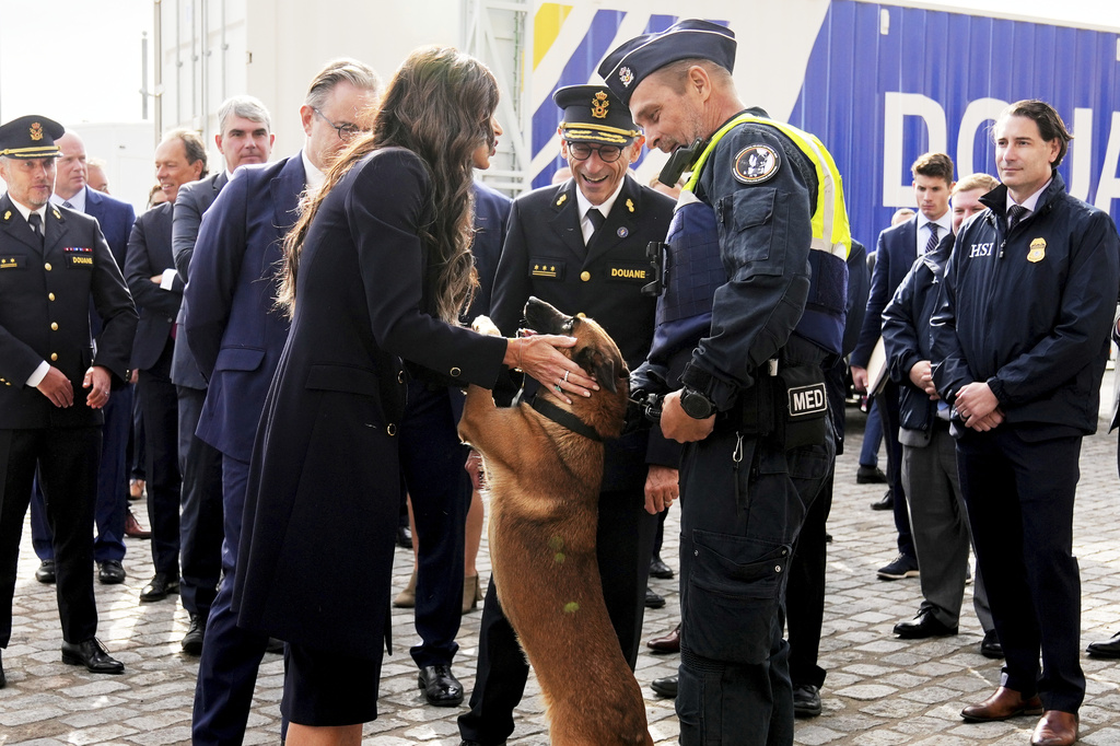 United States Secretary of Homeland Security Kristi Noem greets a container sniffing dog called Emma during a visit to the Port of Antwerp in Antwerp, Belgium, Wednesday, Sept. 10, 2025. (AP Photo/Virginia Mayo)