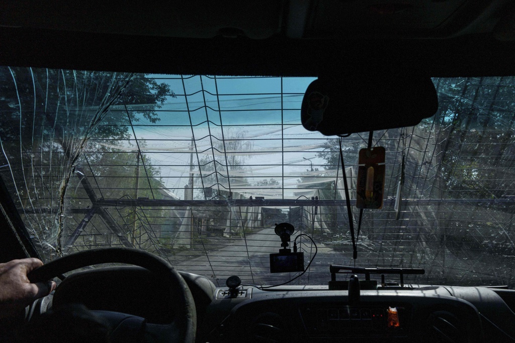 A police van drives on the road with anti-drone nets near Kostiantynivka, Ukraine, Tuesday, Sept. 2, 2025. (AP Photo/Evgeniy Maloletka)