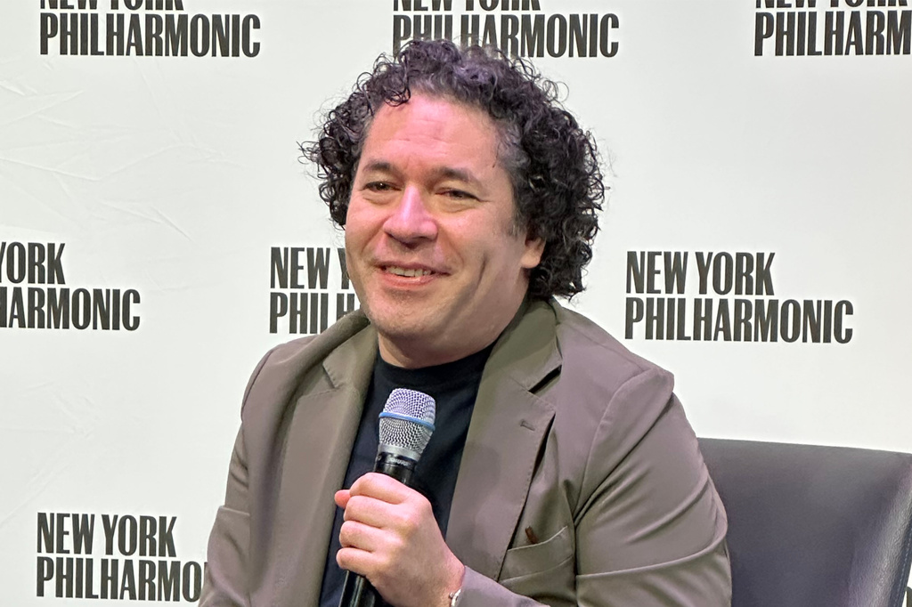 In this photo taken with a smartphone, Conductor Gustavo Dudamel speaks at a news conference at David Geffen Hall in New York on Tuesday, Sept. 8, 2026, a day after beginning his new position as music director for the New York Philharmonic. (AP Photo/Ron Blum)