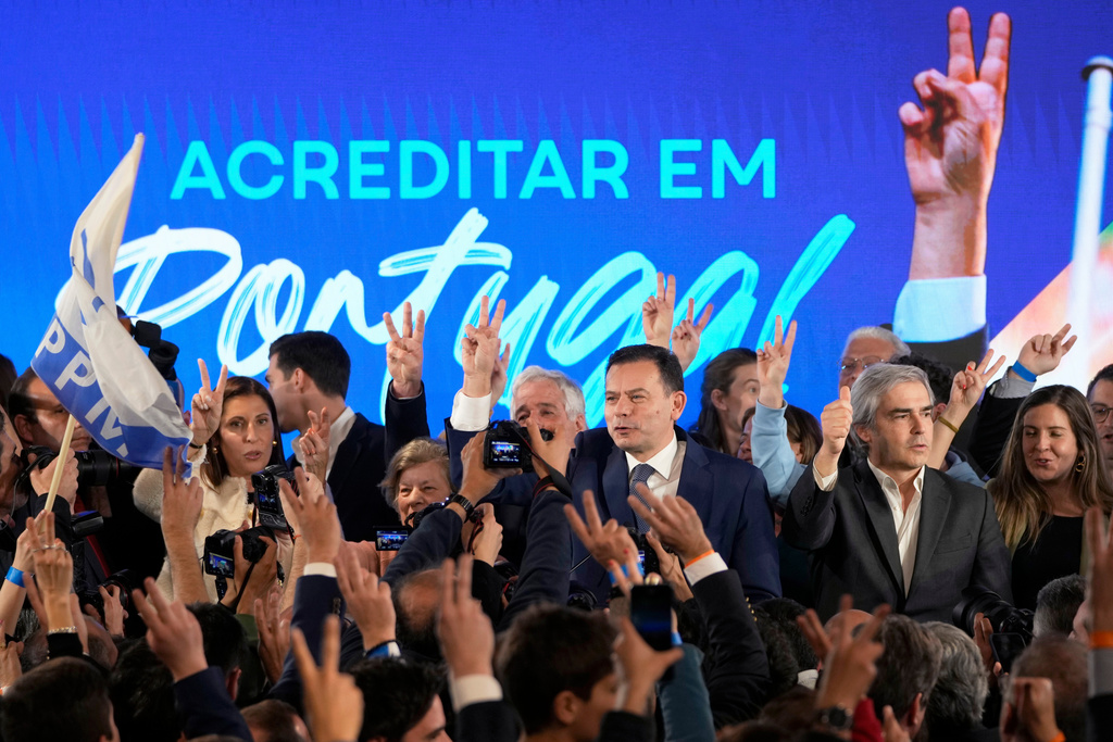 FILE - Luis Montenegro, leader of the center-right Democratic Alliance, center, and his wife Carla, at left, gesture to supporters after claiming victory in Portugal's election, in Lisbon, on March 11, 2024. AP Photo/Armando Franca, File)