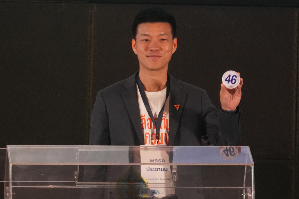 People's Party Natthaphong Ruengpanyawut shows his number after a drawing at a candidate registration in Bangkok, Thailand, Sunday, Dec. 28, 2025. (AP Photo/Sakchai Lalit)