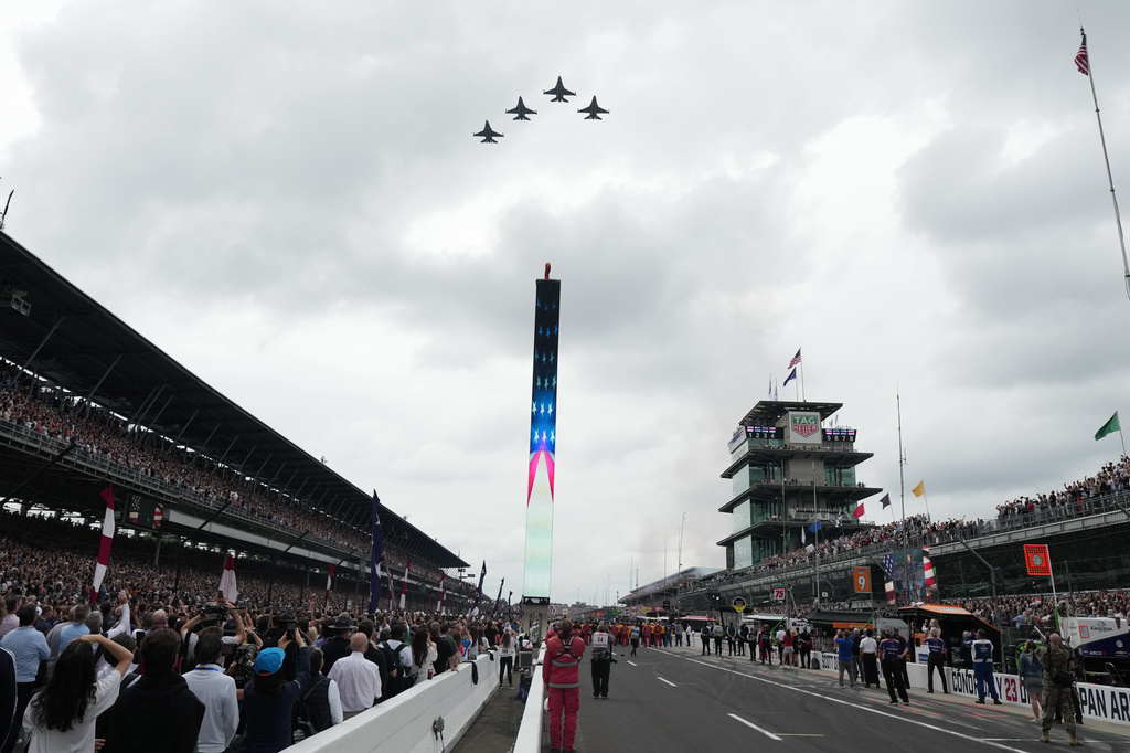 Fighter jets fly over the Indianapolis Motor Speedway during ceremonies before the start of the Indianapolis 500 auto race, Sunday, May 24, 2026 in Indianapolis. (AP Photo/AJ Mast)