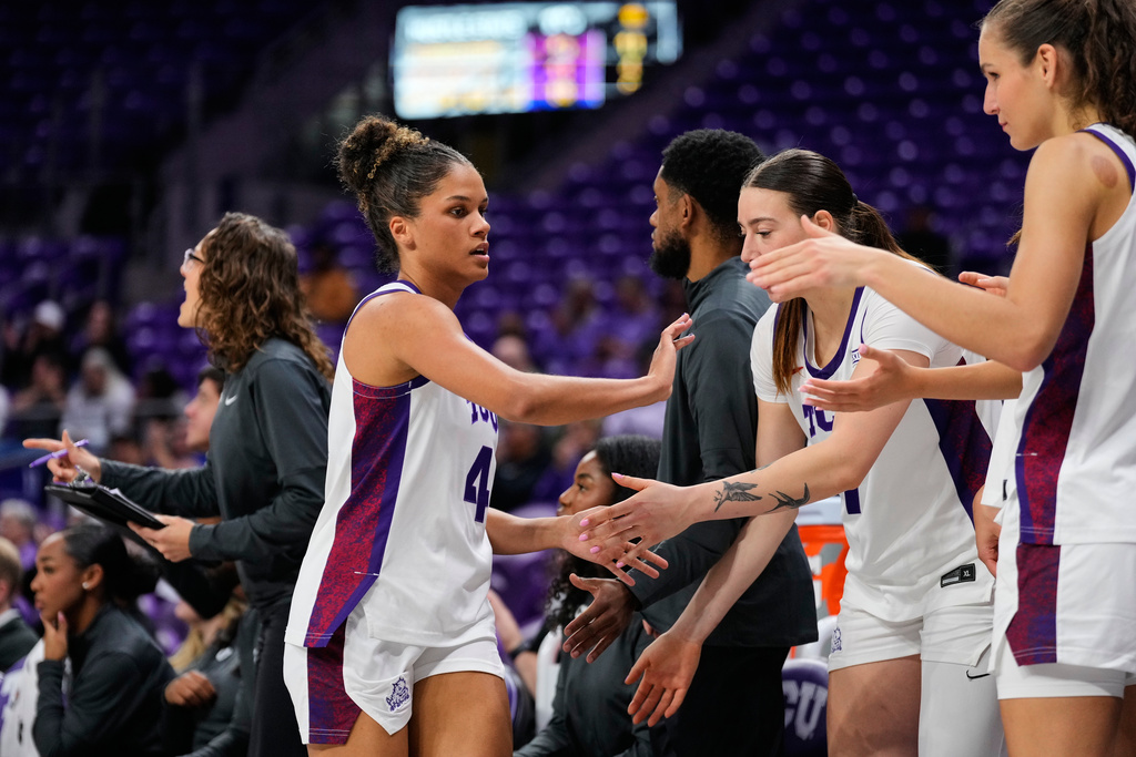 TCU guard Donovyn Hunter, left, is greeted at the bench in the second half of an NCAA college basketball game against Arkansas Pine Bluff in Fort Worth, Texas, Tuesday, Dec. 16, 2025. (AP Photo/Tony Gutierrez)