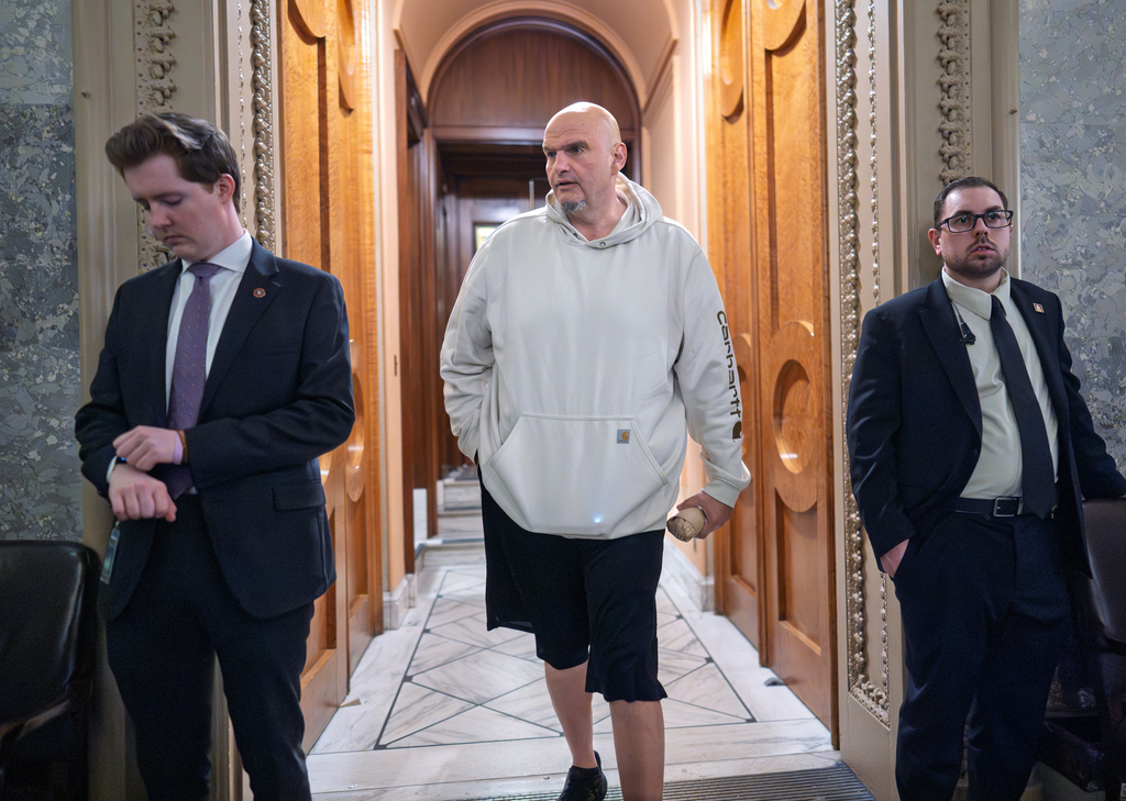 Sen. John Fetterman, D-Pa., a Democrat who has been voting to open the government, leaves the chamber as the Senate works to bring the longest government shutdown in U.S. history to an end after a bipartisan compromise, at the Capitol in Washington, Monday, Nov. 10, 2025. (AP Photo/J. Scott Applewhite)