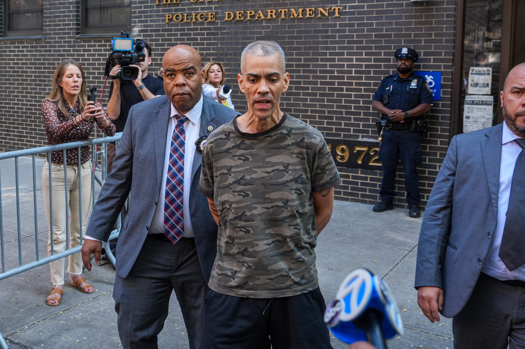 Raul Morales, a 51-year-old man who is accused of stabbing two people on the Upper West Side in Manhattan on Thursday afternoon is escorted out of the NYPD 20th Precinct by police officers in New York, Friday, July 24, 2026. (AP Photo/Ryan Murphy)