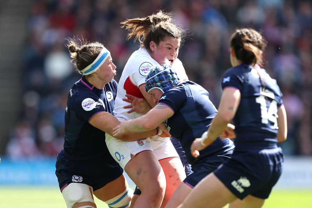 England's Maud Muir is tackled by Scotland's Rachel Malcolm, left, and Lana Skeldon during the Women's Six Nations rugby match between Scotland and England in Edinburgh, Scotland, Saturday April 18, 2026. (Ewan Bootman/PA via AP)