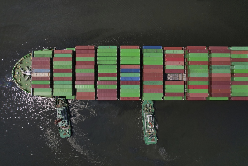 FILE - Tugboats assist a container ship as it prepares to dock at the Manila International Container Terminal at the Philippine capital April 8, 2025. (AP Photo/Aaron Favila)