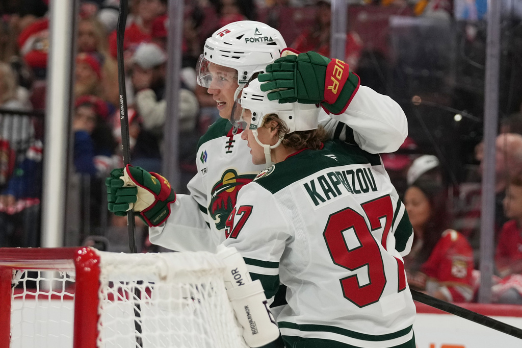 Minnesota Wild left wing Kirill Kaprizov (97) is congratulated after scoring a goal during the first period of an NHL hockey game against the Florida Panthers, Saturday, Oct. 10, 2026, in Sunrise, Fla. (AP Photo/Lynne Sladky)