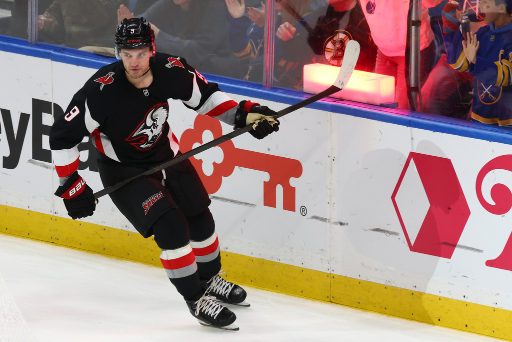 Buffalo Sabres center Josh Norris celebrates his empty net goal during the third period of an NHL hockey game against the Boston Bruins, Saturday, Dec. 27, 2025, in Buffalo, N.Y. (AP Photo/Jeffrey T. Barnes)