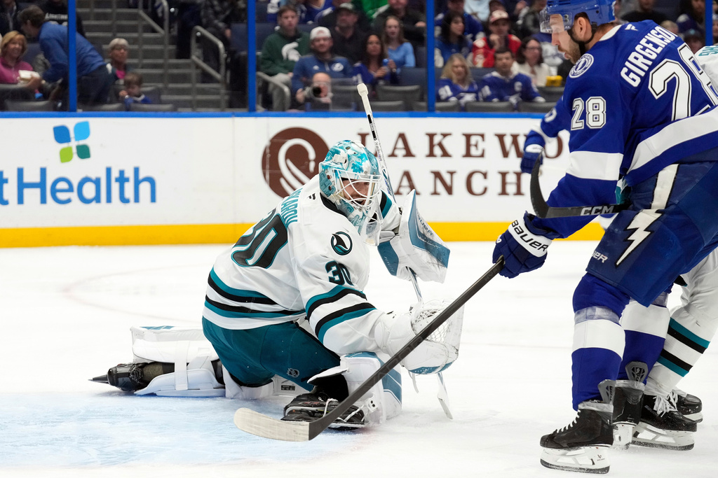 San Jose Sharks goaltender Yaroslav Askarov (30) makes a save on a shot by Tampa Bay Lightning center Zemgus Girgensons (28) during the second period of an NHL hockey game Tuesday, Jan. 20, 2026, in Tampa, Fla. (AP Photo/Chris O'Meara)