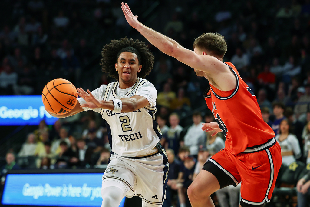 Georgia Tech guard Eric Chatfield Jr. (2) passes against Virginia guard Dallin Hall, right, during the first half of an NCAA college basketball game, Wednesday, Feb. 18, 2026, in Atlanta. (AP Photo/Colin Hubbard)