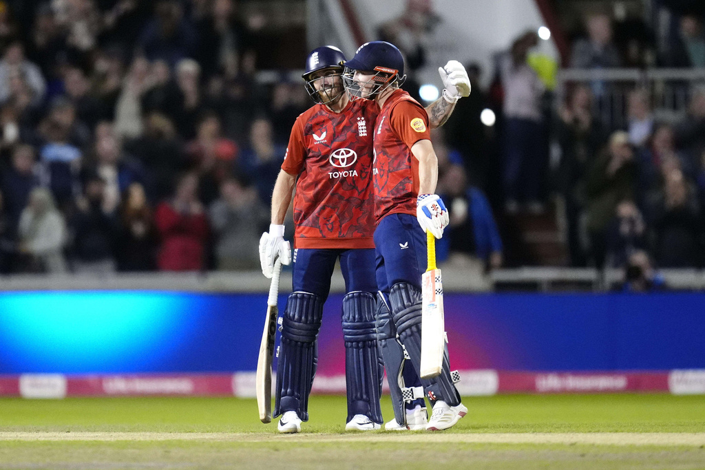 England's Phil Salt, left, and Harry Brook celebrate after finishing the first innings on 304 runs against South Africa during the second International T20 Match at Emirates Old Trafford in Manchester, England, Friday, Sept. 12, 2025. (Nick Potts/PA via AP)