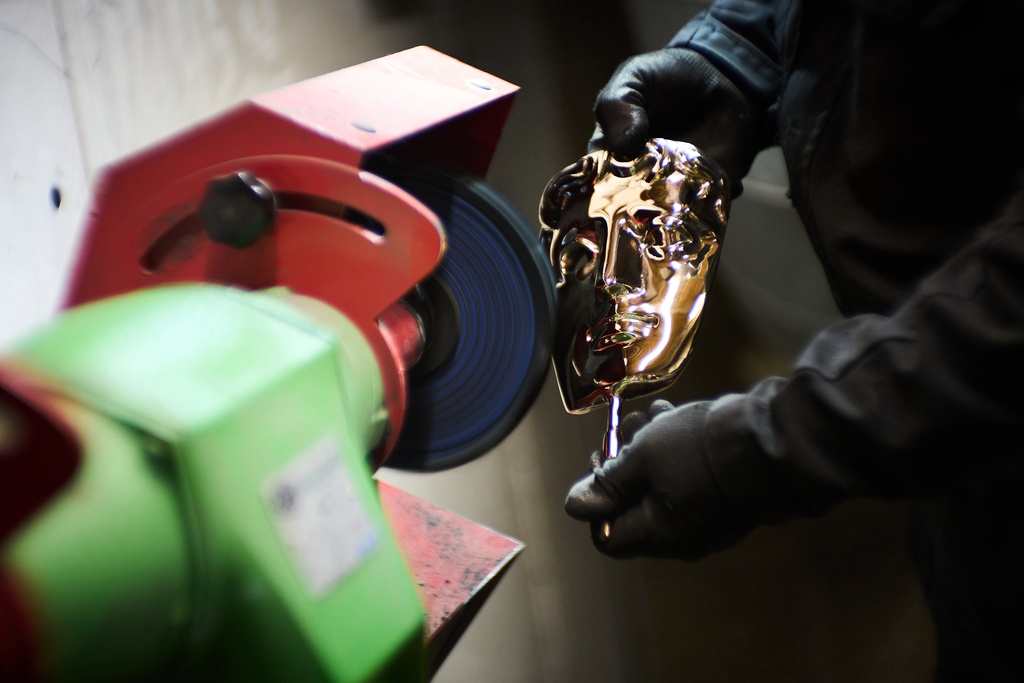 A British Academy Film Awards mask is polished as part of the process to create BAFTA masks at FSE Foundry in Braintree, England on Tuesday, Feb. 10, 2026. (Scott A Garfitt/Invision/AP)