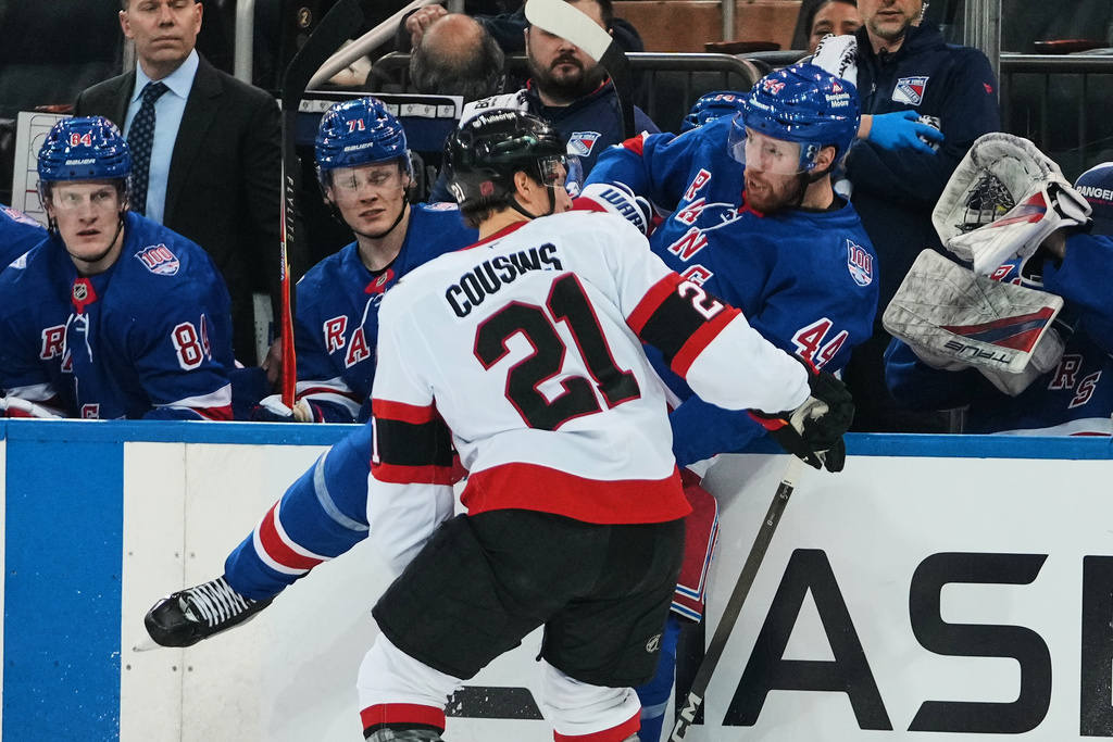 Ottawa Senators' Nick Cousins (21) checks New York Rangers' Vladislav Gavrikov (44) during the second period of an NHL hockey game Monday, March 23, 2026, in New York. (AP Photo/Frank Franklin II)