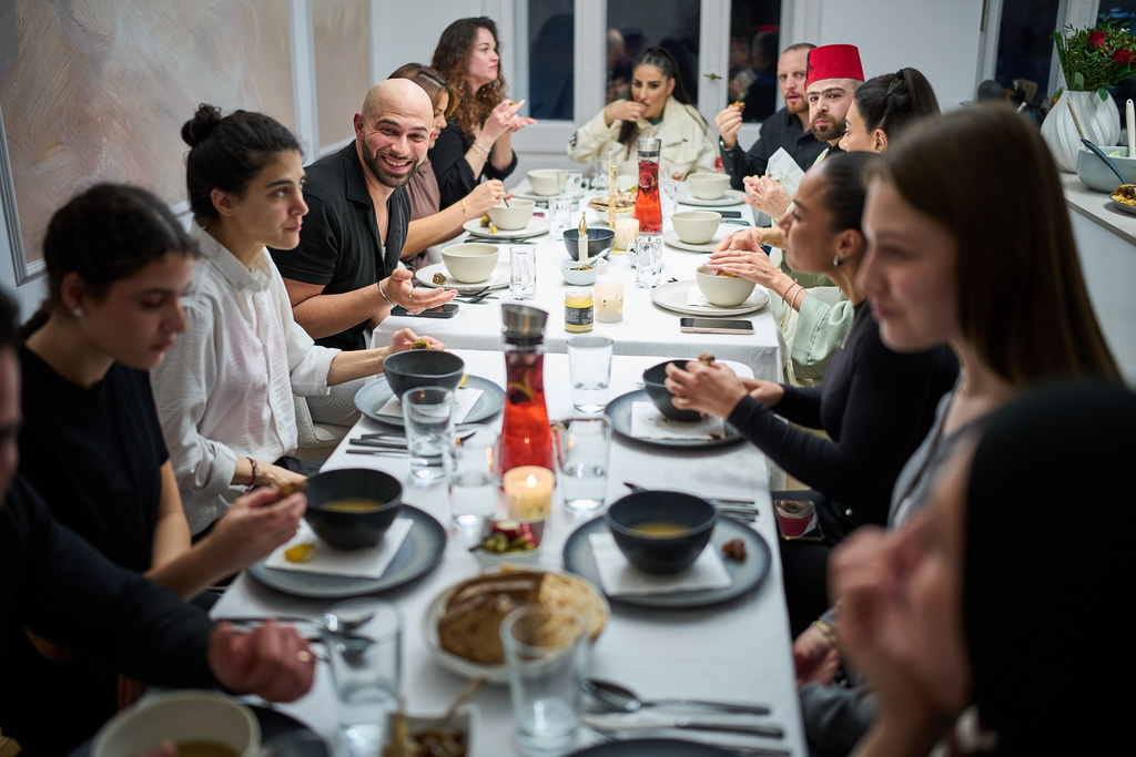 Gay Muslim influencer Ali Darwich, center left, hosts an inclusive Iftar, the Ramadan fast-breaking meal, with friends who are Muslim, Christian, queer and straight, in Berlin, Germany, Wednesday, March 11, 2026. (AP Photo/Ebrahim Noroozi)