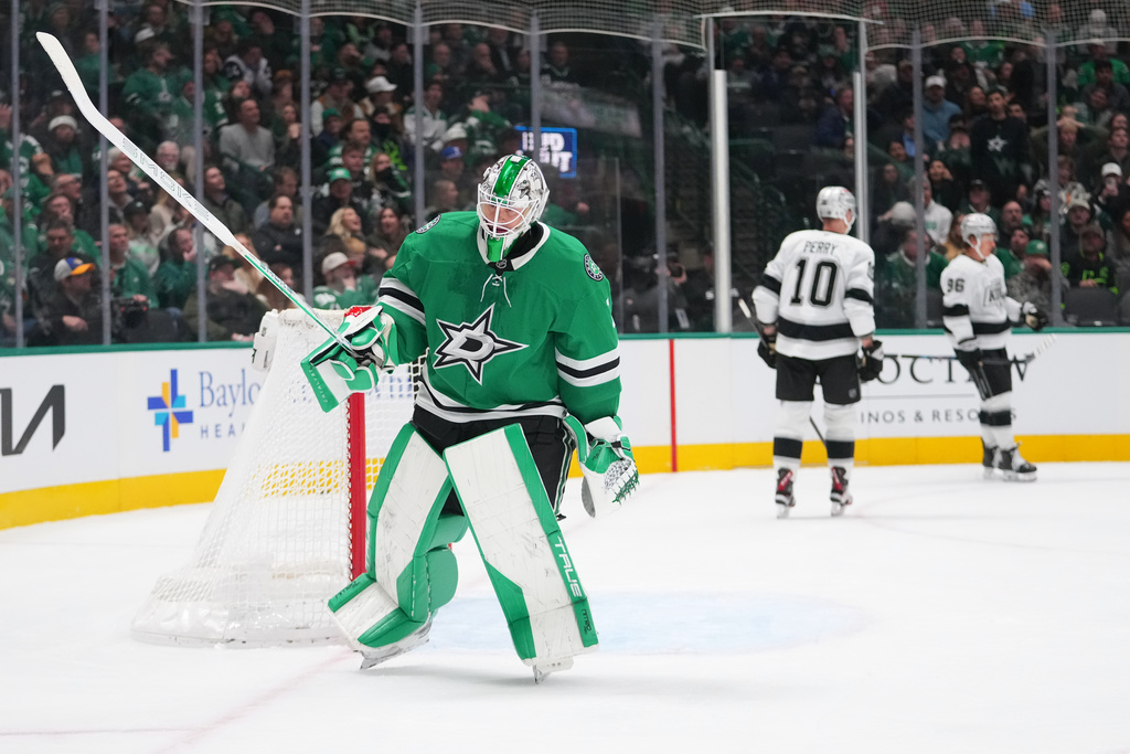 Dallas Stars goaltender Casey Desmith, left, skates away as Los Angeles Kings left wing Andrei Kuzmenko, far right, celebrates his second period goal with right wing Corey Perry (10) during an NHL hockey game Monday, Dec. 15, 2025, in Dallas. (AP Photo/Julio Cortez)