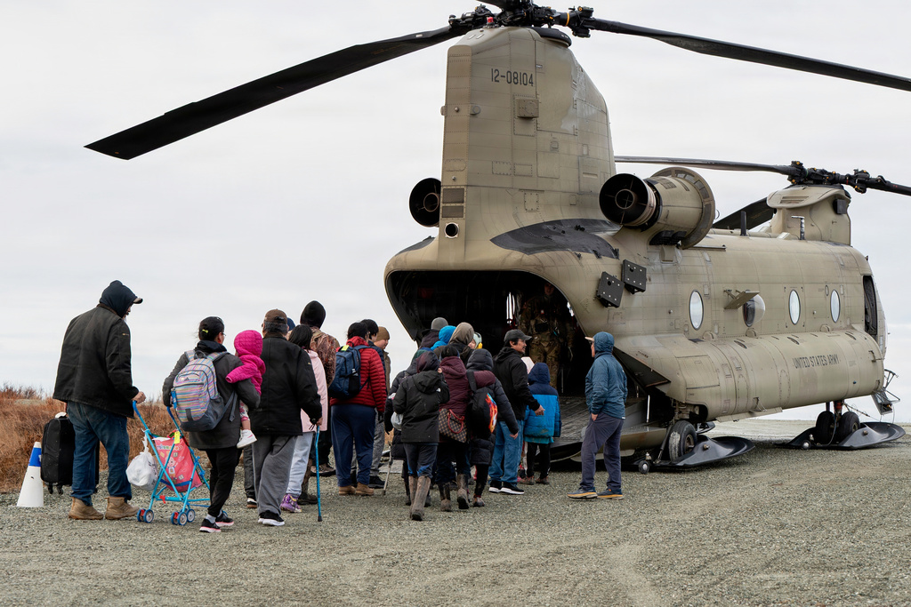 In this photo provided by the Alaska Army National Guard, displaced people are evacuated from Kwigillingok, Alaska, on Thursday, Oct. 16, 2025, following Typhoon Halong that struck Alaska's west coast. (Joseph Moon/Alaska National Guard via AP)