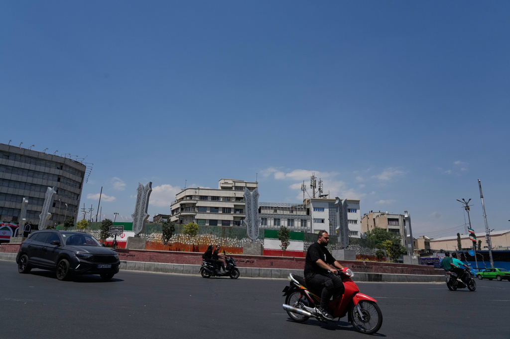 Vehicles drive at the Islamic Revolution square in Tehran, Iran, Monday, June 8, 2026. (AP Photo/Vahid Salemi)