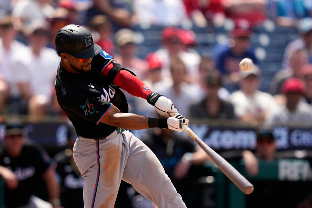 Miami Marlins' Otto Lopez hits an RBI-sacrifice fly against Philadelphia Phillies pitcher Tanner Banks during the sixth inning of a baseball game Wednesday, June 17, 2026, in Philadelphia. (AP Photo/Matt Slocum)