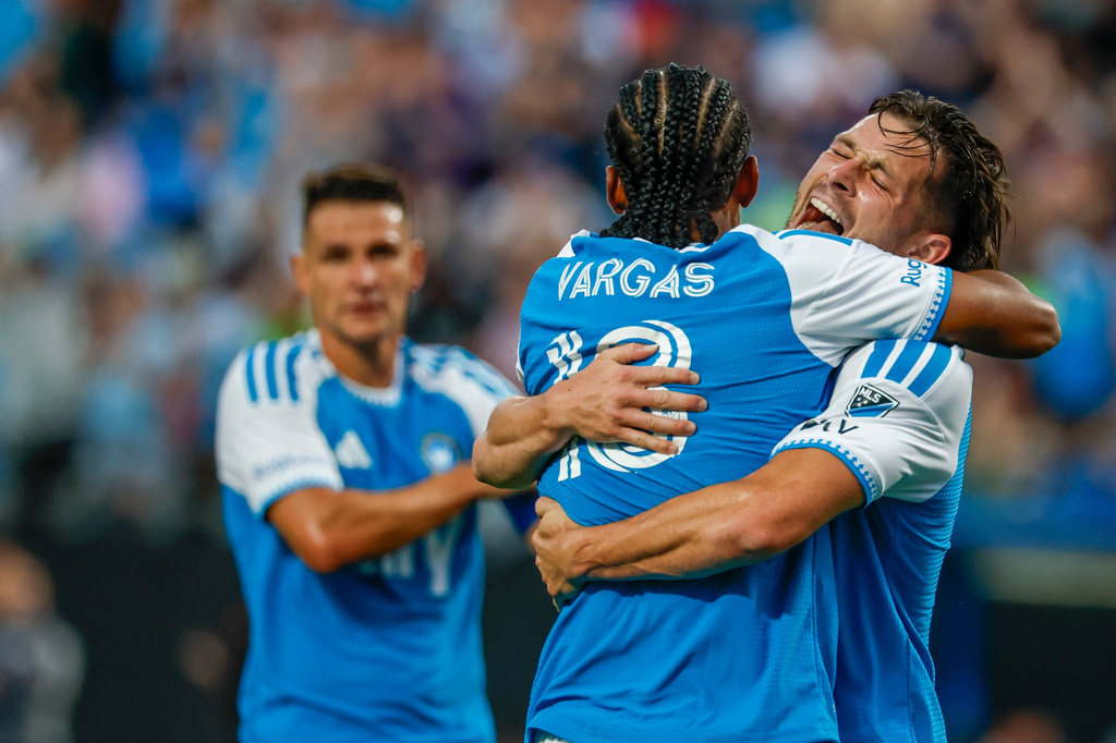 Charlotte FC midfielder Brandt Bronico, right, hugs forward Kerwin Vargas, front left, after a goal against Toronto FC during the first half of an MLS soccer match in Charlotte, N.C., Saturday, May 16, 2026. (AP Photo/Nell Redmond)