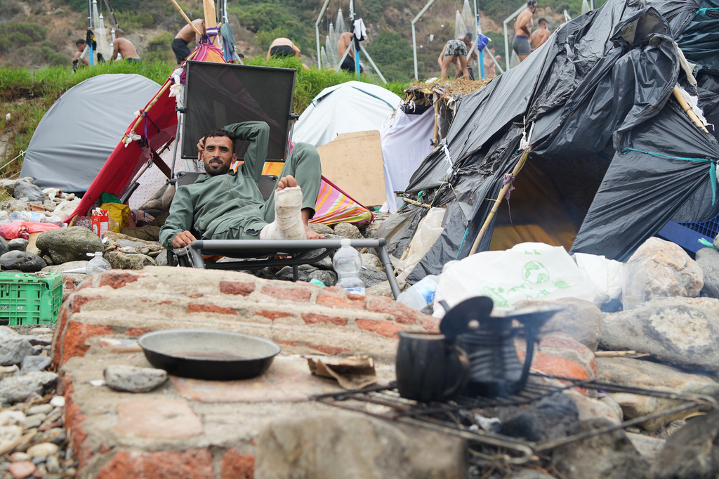 A migrant sits next to his tent at El Trampolín beach in the Spanish exclave of Ceuta, Wednesday, Sept. 2, 2026. (AP Photo/Francis González)