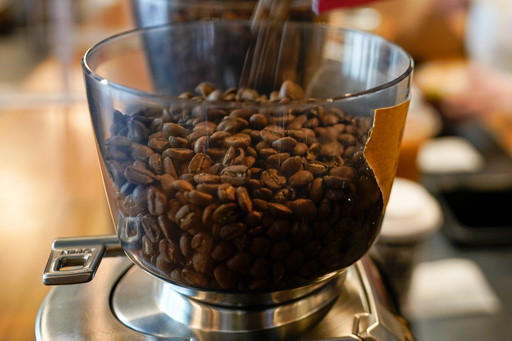 FILE - Coffee beans are poured into a grinder at a cafe in College Park, Md., on Wednesday, Sept. 1, 2021. (AP Photo/Julio Cortez, File) FILE - Coffee beans are poured into a grinder at a cafe in College Park, Md., on Wednesday, Sept. 1, 2021. (AP Photo/Julio Cortez, File)
