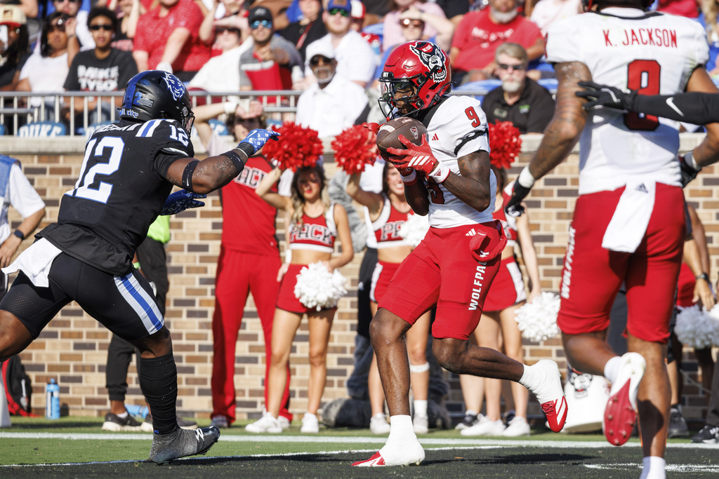 North Carolina State's Terrell Anderson (9) makes a catch for a touchdown ahead of Duke's Tre Freeman (12) during the first half of an NCAA college football game in Durham, N.C., Saturday, Sept. 20, 2025. (AP Photo/Ben McKeown)