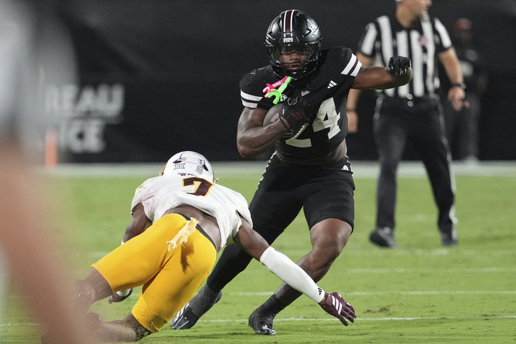 Mississippi State running back Fluff Bothwell (24) dodges a tackle-attempt by Arizona State defensive back Montana Warren (7) during the first half of an NCAA college football game in Starkville, Miss., Saturday, Sept. 6, 2025. (AP Photo/Rogelio V. Solis)