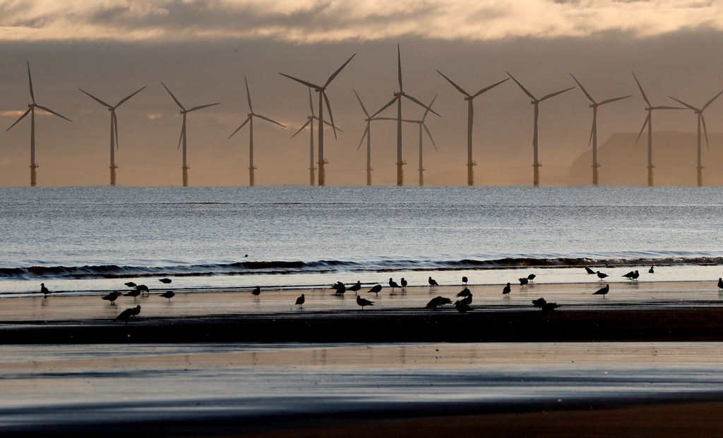 FILE - An offshore wind farm is visible from the beach in Hartlepool, England, Nov. 12, 2019. (AP Photo/Frank Augstein, File)