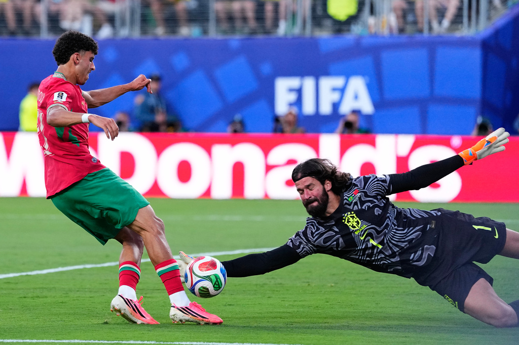 Brazil goalkeeper Alisson Becker, right, makes a save against Morocco's Ayoub Amaimouni during the World Cup Group C soccer match between Brazil and Morocco in East Rutherford, N.J., near New York, Saturday, June 13, 2026. (AP Photo/Petr David Josek)