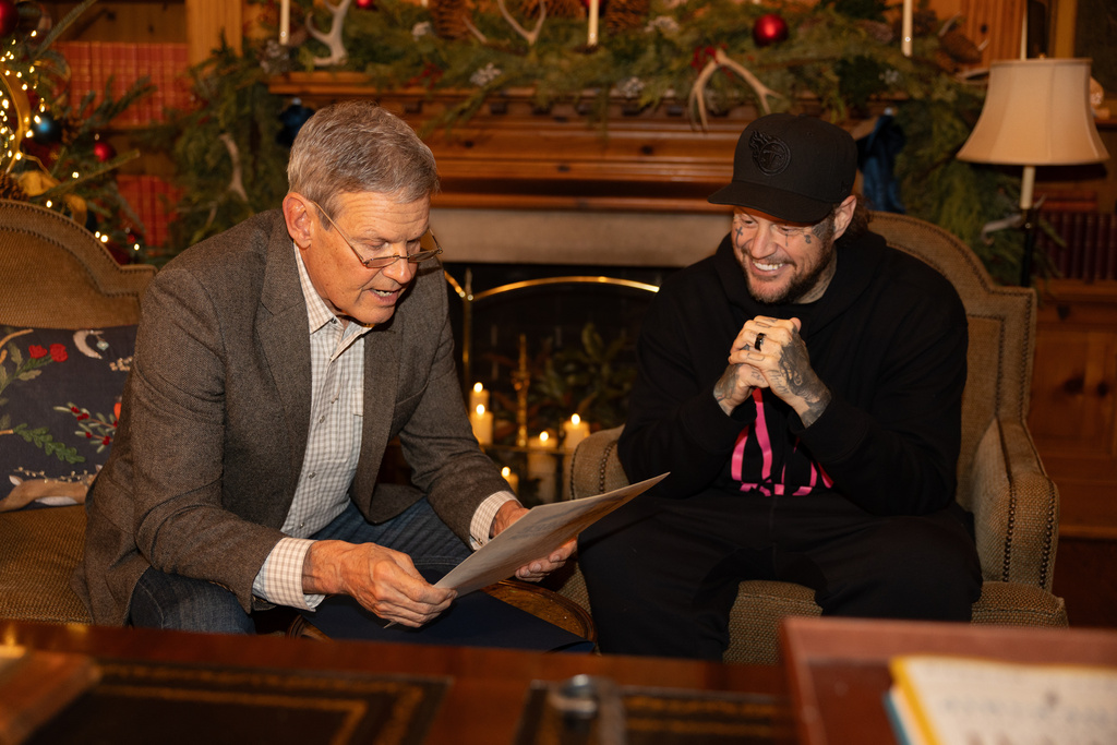 This photo provided by the office of Tennessee Gov. Bill Lee shows Gov. Bill Lee, left, giving country musician Jelly Roll news of his official pardon Thursday, Dec. 18, 2025, at the Tennessee Governor's Mansion in Oak Hill, Tenn. (Brandon Hull/Office of Gov. Bill Lee via AP)