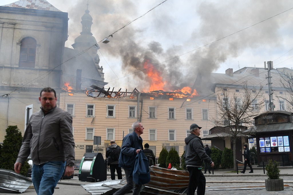 Fire and smoke raises above the city center following Russia's drone attack in Lviv, Ukraine, Tuesday, March 24, 2026. (AP Photo/Mykola Tys)
