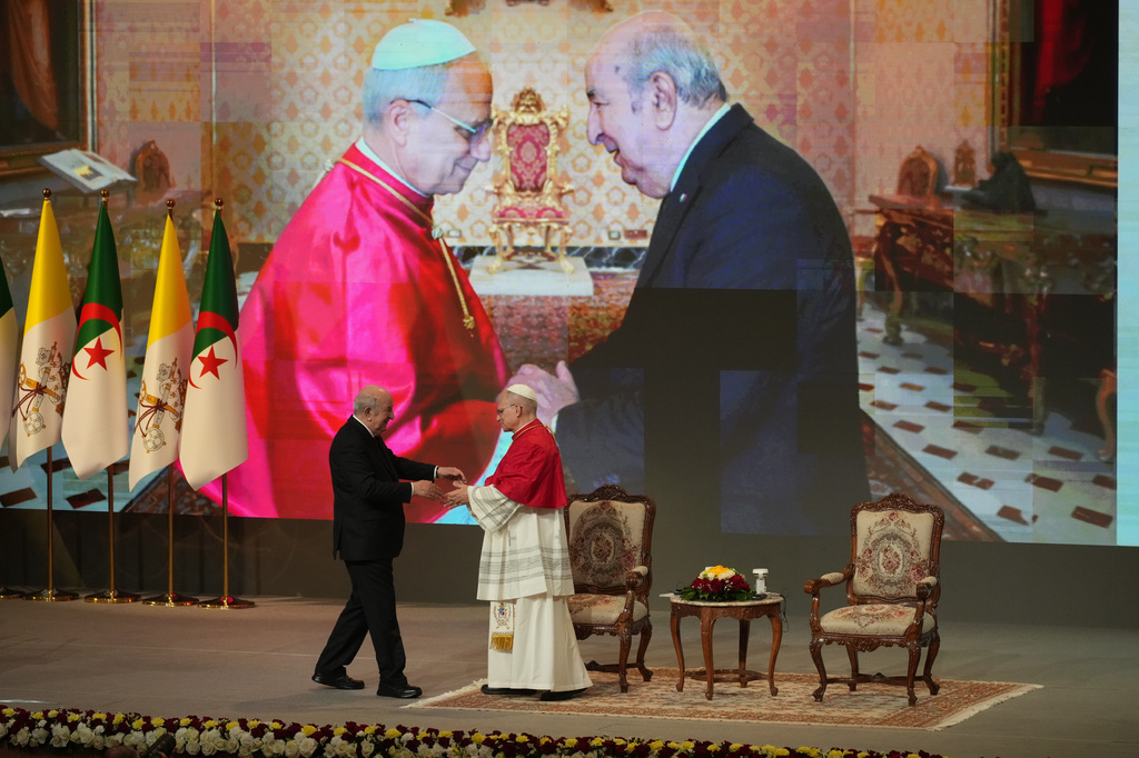 Pope Leo XIV is greeted by President Abdelmadjid Tebboune, left, at the Djamaa el Djazair Conference Center during a meeting with Algerian authorities, members of the civil society, and diplomatic corps in Algiers, Monday, April 13, 2026, on the first day of an 11-day apostolic journey to Africa. (AP Photo/Andrew Medichini)