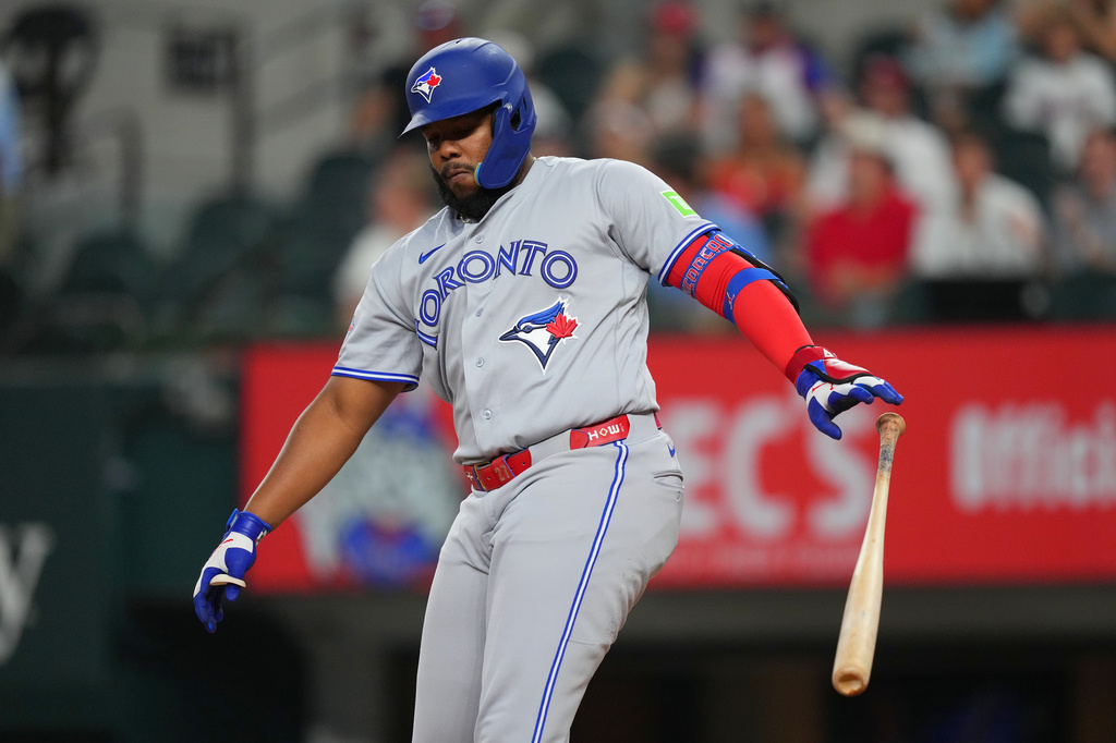 Toronto Blue Jays' Vladimir Guerrero Jr. reacts after striking out swinging against Texas Rangers starting pitcher Kumar Rocker during the first inning of a baseball game Friday, Sept. 18, 2026, in Arlington, Texas. (AP Photo/Julio Cortez)